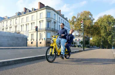 Deux personnes circulant à vélo urbain sur une piste cyclable à Nantes, illustrant les nouveaux usages de la mobilité douce en ville.